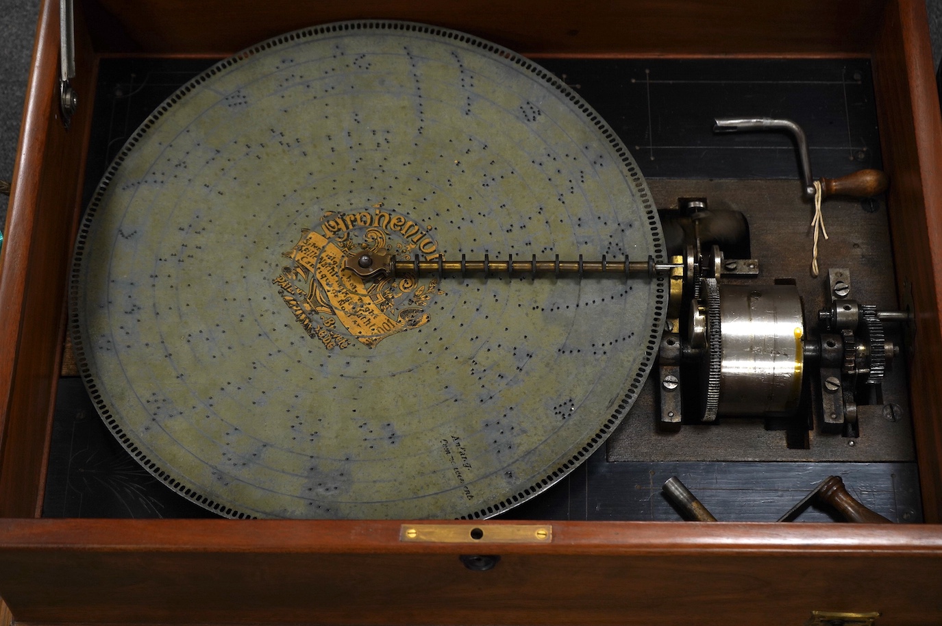 A walnut cased Orphenion, the replacement case is understood to have been constructed from panels from RMS Mauretania, 64cm wide, 49cm deep, 23cm high, with twenty-two 41cm diameter discs. Condition - good.